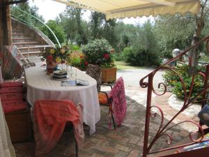 a table with flowers on it on a patio at Agriturismo PeterPan in Pietra Ligure