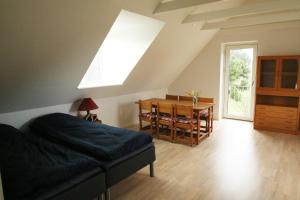 a bedroom with a bed and a dining room table at Stenbrogård in Harlev