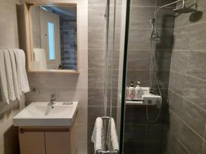 a bathroom with a shower and a sink at Tongyeong Bridge Hotel in Tongyeong