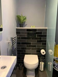 a bathroom with a white toilet and a sink at Egremont House - Brighton Rock Rooms in Brighton & Hove