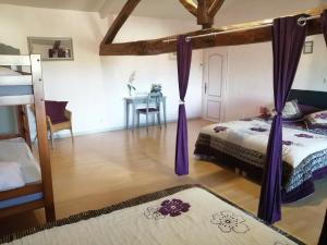 a bedroom with two beds and a desk at les tourterelles in Chabournay