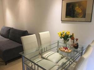 a living room with a glass table and a couch at Apartament na wydmie in Ustka