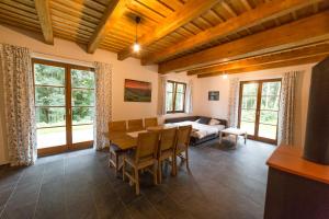 a living room with a table and a bed at U Staré hájenky in Jindřichov