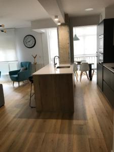 a kitchen with a island in the middle of a room at Acogedor apartamento en Zumaia in Zumaia