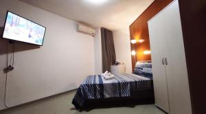 a bedroom with a bed and a television at Villa Klara Eilat in Eilat