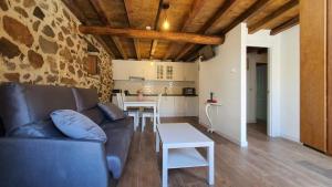 a living room with a couch and a table at Casas del Castillo, 1 in Ávila +7 photos