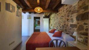 a bedroom with a bed and a table in a room at Casas del Castillo, 1 in Ávila