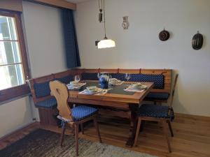 a dining room table with chairs and a table and a table and chairsuggest at Chalet Garnedel in Breil/Brigels
