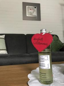 a bottle with a heart on top of a table at Haus Mittelberg in Olsberg +25 photos