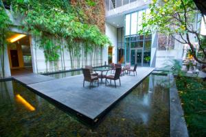 a patio with a table and chairs in a building at BoonRumpa Accommodation in Bangkok