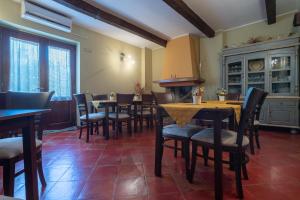 a dining room with tables and chairs and a fireplace at Hotel Don Giovanni in Ururi