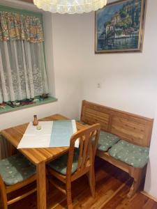 a dining room with a wooden table and chairs at Apartma Ajdovka Rogla in Vitanje