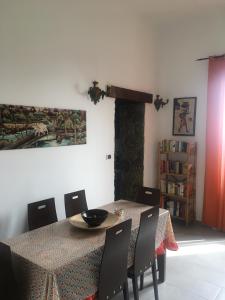 a dining room with a table and chairs at Casa Bucalo in Taormina