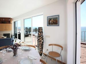 a dining room with a table and chairs and the ocean at Sitges Views in Sitges