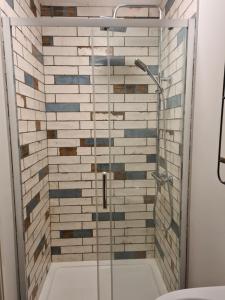 a shower with a glass door in a bathroom at Derwentwater Arms in Curbar