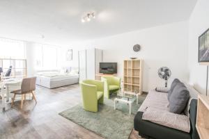 a living room with a couch and a table at Apartmenthaus Aalen in Aalen