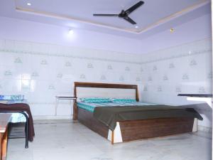 een slaapkamer met een bed en een plafondventilator bij Ushodaya Resorts in Araku