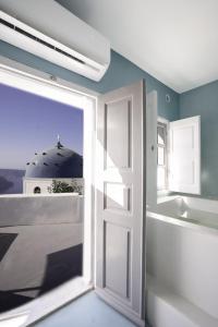 an open door in a room with a window at Imer Villas in Imerovigli
