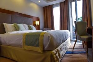Voodi või voodid majutusasutuse Admas Grand Hotel toas