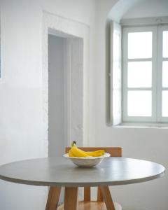 a bowl of bananas sitting on a table in a room at Imer Villas in Imerovigli