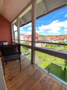 a room with a large window with a view at SUITE EISENACH direkt am Bahnhof in Eisenach