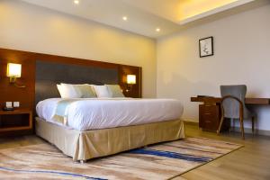 Voodi või voodid majutusasutuse Admas Grand Hotel toas