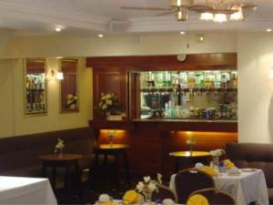 a restaurant with two tables and a bar at Gleneagles - Albert Road in Blackpool