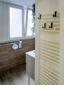 baño con lavabo y ventana en La Piccola Corte, en Trieste