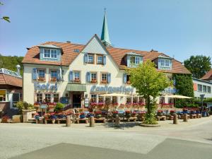 a large building with flowers in front of it at Luxusapartment Burgschänke in Kaiserslautern