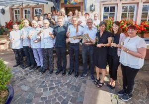 a group of people posing for a picture with wine glasses at Luxusapartment Burgschänke in Kaiserslautern