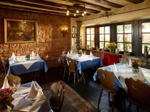 a restaurant with tables and chairs in a room at Luxusapartment Burgschänke in Kaiserslautern
