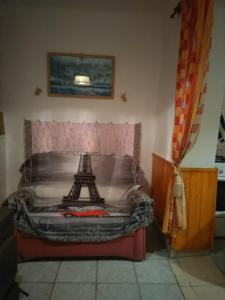 a bedroom with a bed with the eiffel tower on it at Rózsa vendégház in Abádszalók