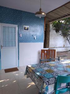 a dining room with a table and a blue wall at Cantinho especial in Recife