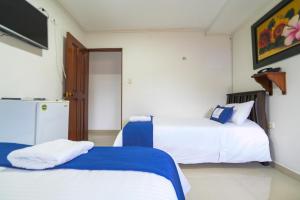 Postel nebo postele na pokoji v ubytování Hotel Aquarius