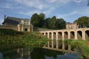 a bridge over a river with a building in the background at Holiday Inn Express Arras, an IHG Hotel in Arras