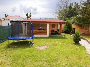 a yard with a swing in front of a house at House Hanka, High Tatras in Stará Lesná