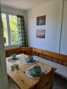 a wooden table with plates and bowls on it at Het Hongaarse Vissershuisje in Dunaszekcső +17 photos