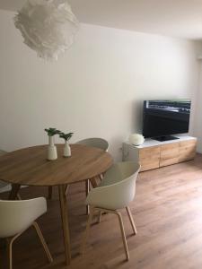 a dining room with a table and chairs and a television at Wohnung Haus St. Martin in Zermatt