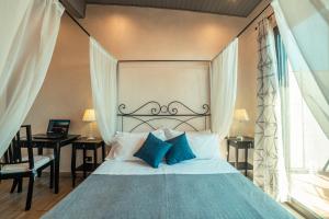 a bedroom with a bed with a headboard and a window at B&B Marranzano in Giardini Naxos