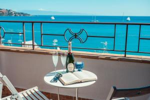 
a table that has a glass of wine on it at B&B Marranzano in Giardini Naxos
