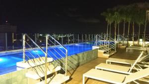 a view of a swimming pool at night at Edifício Time Apto 410 in Maceió
