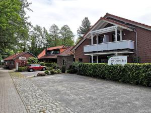 uma casa de tijolos com um carro estacionado em frente em Hotel Dat greune Eck em Soltau