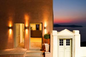 a building with a door and a view of the ocean at Panorama Boutique Hotel in Fira