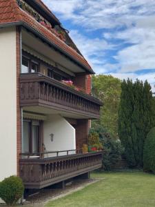 a house with a balcony on the side of it at Ferienwohnung „Am Rodenberg“ in Bad Harzburg