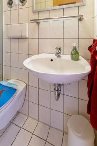 a bathroom with a white sink and a toilet at Ferienwohnung Big Family in Ichenhausen