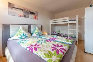 a bedroom with a large bed with colorful pillows at Ferienwohnung Big Family in Ichenhausen