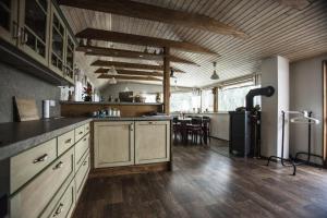 a large kitchen with wooden floors and a dining room at Ve Stodole in Zlatá Olešnice