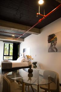 a bedroom with a bed and a glass table at The Coffee Club in Manizales