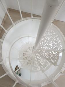 a spiral staircase with a white ceiling at AMPHIORAMA in La Spezia