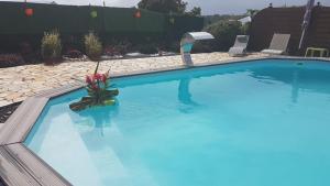 a large blue swimming pool with two chairs in it at Villa Ludivine in Sainte-Anne